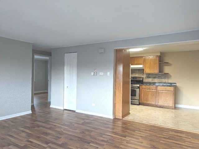 empty room featuring dark hardwood / wood-style flooring, a textured ceiling, and crown molding