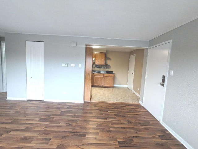 kitchen featuring backsplash, stainless steel appliances, sink, light tile patterned floors, and an AC wall unit