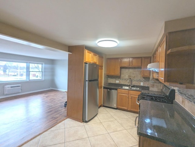 kitchen featuring stainless steel gas range oven, light tile patterned floors, and tasteful backsplash