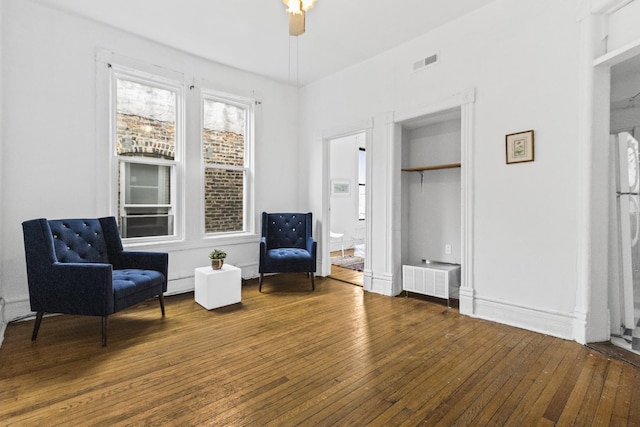 living area with hardwood / wood-style flooring and ceiling fan