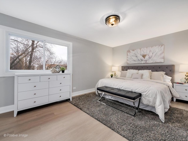 bedroom featuring hardwood / wood-style floors and multiple windows