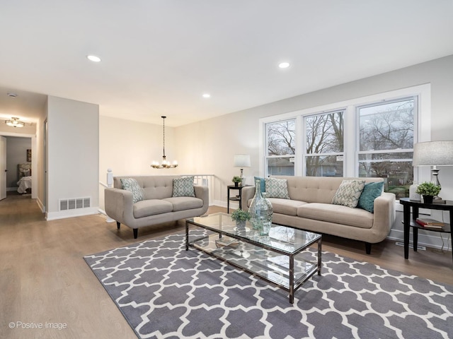 living room featuring a notable chandelier and wood-type flooring