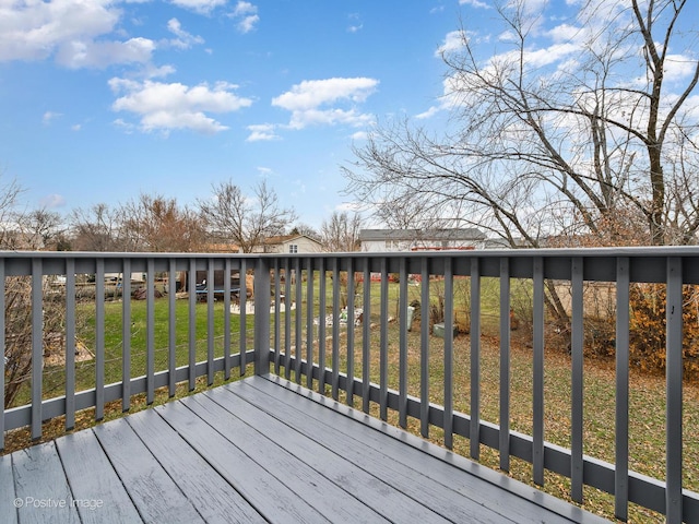 wooden deck featuring a lawn