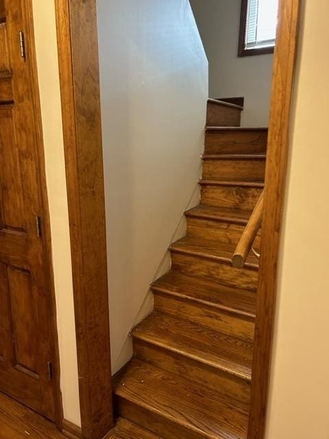 stairs featuring hardwood / wood-style flooring