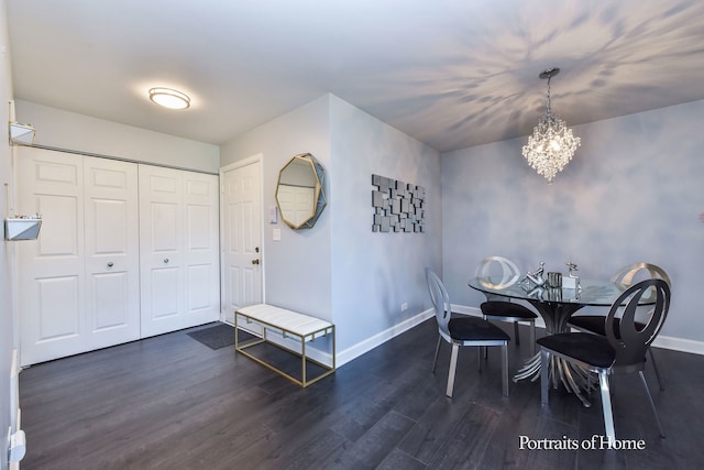 dining room featuring dark hardwood / wood-style floors and a chandelier