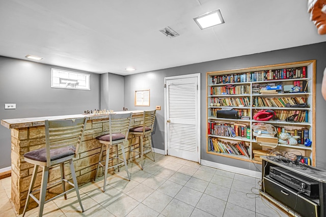 bar with light tile patterned floors