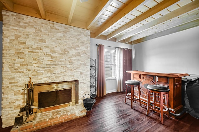 bar featuring beamed ceiling, a fireplace, wooden ceiling, and dark wood-type flooring