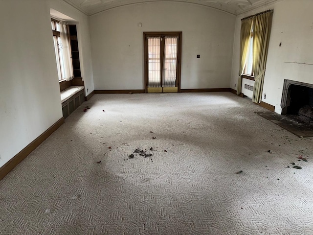 unfurnished living room with brick ceiling and lofted ceiling