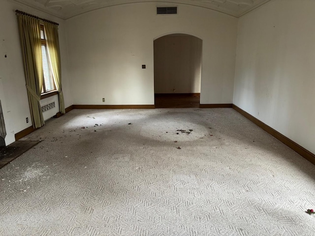 empty room featuring lofted ceiling