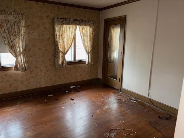 unfurnished room with wood-type flooring and crown molding