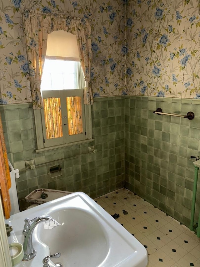 bathroom featuring tile walls and sink