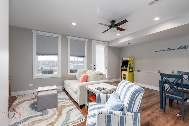 living room with ceiling fan and dark hardwood / wood-style flooring