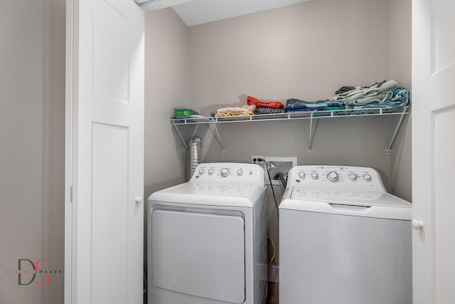 clothes washing area with washing machine and dryer