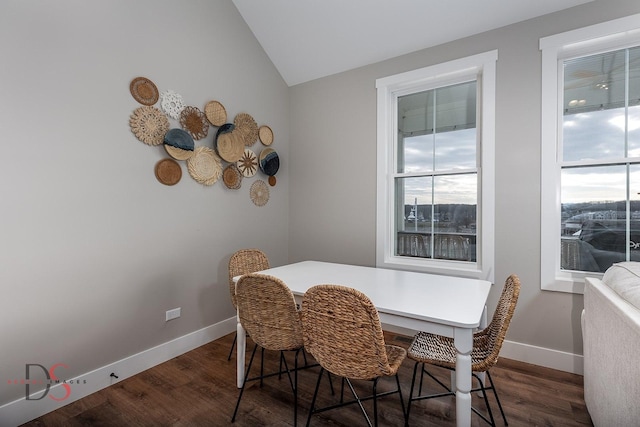 dining room with dark hardwood / wood-style floors and vaulted ceiling