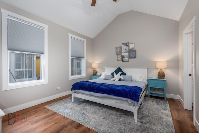 bedroom featuring dark hardwood / wood-style floors, vaulted ceiling, and ceiling fan