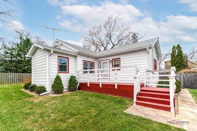 back of house with a lawn and a wooden deck