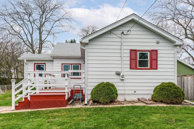 back of house with a yard and a wooden deck