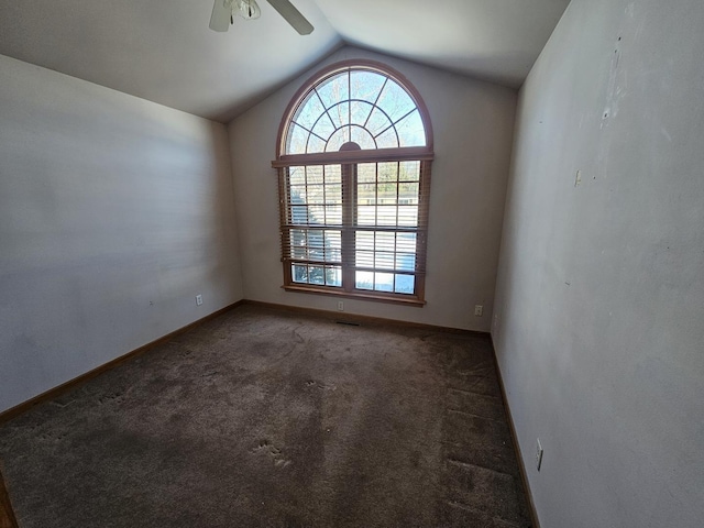 carpeted empty room with ceiling fan and vaulted ceiling