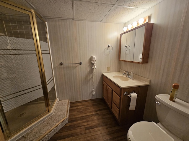 full bathroom featuring vanity, toilet, wood-type flooring, and bath / shower combo with glass door