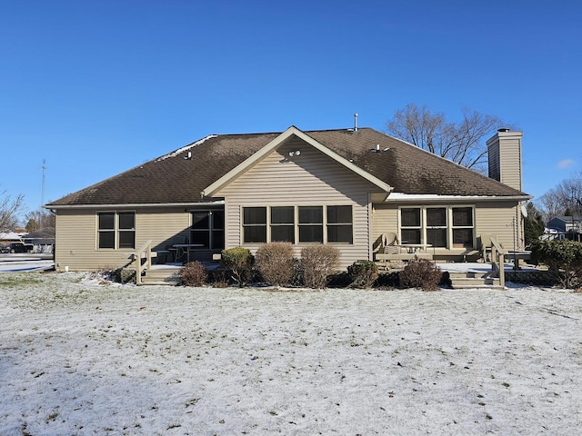 snow covered property featuring a patio area