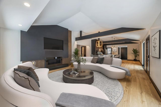 living room featuring lofted ceiling and light wood-type flooring