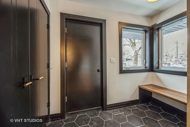 entryway featuring dark tile patterned floors