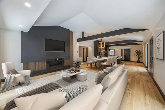 living room with lofted ceiling and light hardwood / wood-style floors