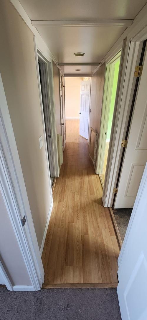 hallway with light hardwood / wood-style flooring