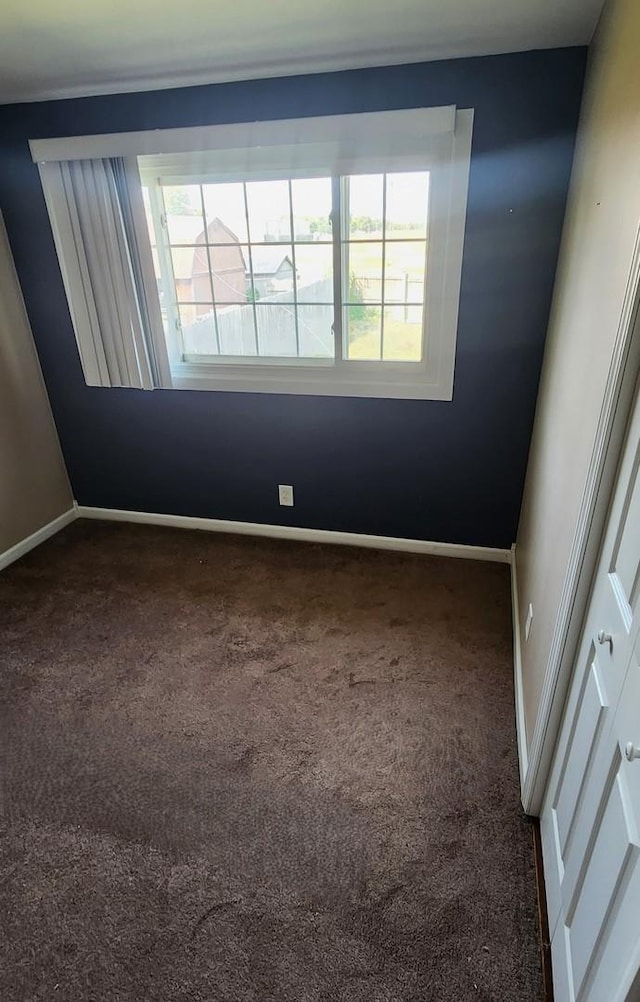 carpeted empty room with plenty of natural light