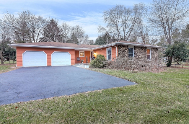 ranch-style house featuring a garage and a front yard