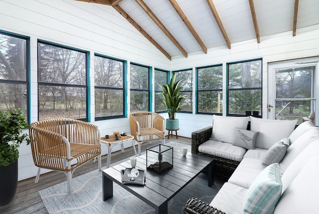 sunroom / solarium featuring vaulted ceiling with beams