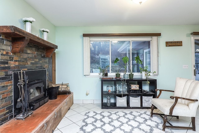 living room featuring light tile patterned floors and a wood stove