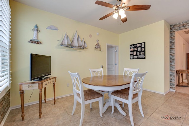 dining space featuring ceiling fan and light tile patterned flooring