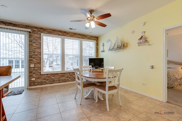 dining space with ceiling fan and light tile patterned floors