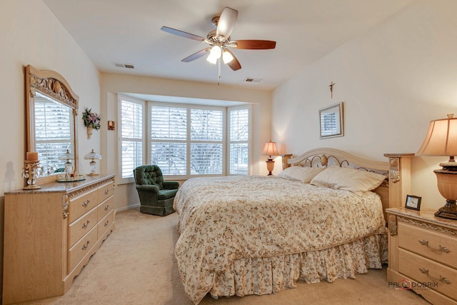 carpeted bedroom with multiple windows and ceiling fan