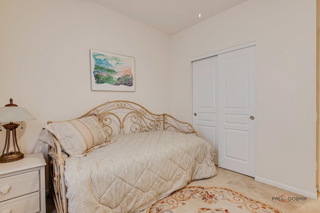 bedroom with light carpet and a closet