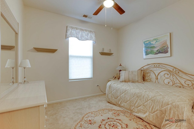 carpeted bedroom featuring ceiling fan and multiple windows