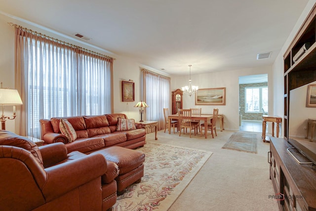 living room featuring light carpet and a notable chandelier