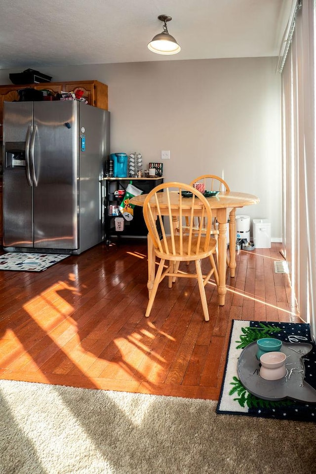 dining area with dark hardwood / wood-style flooring