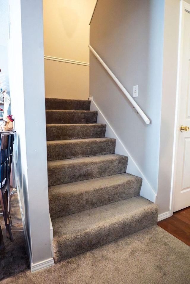 stairway featuring wood-type flooring