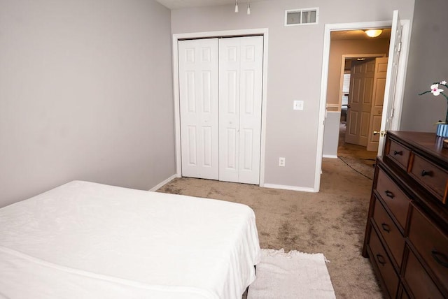 carpeted bedroom with a closet