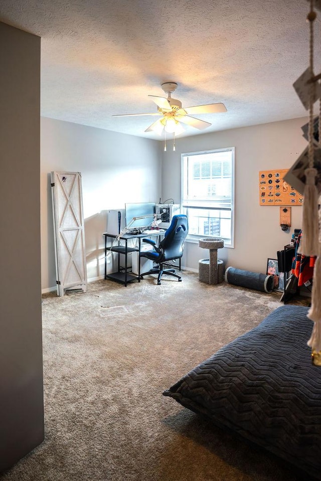 bedroom with carpet flooring, ceiling fan, and a textured ceiling