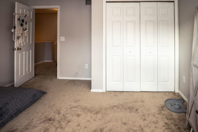 unfurnished bedroom featuring carpet and a closet