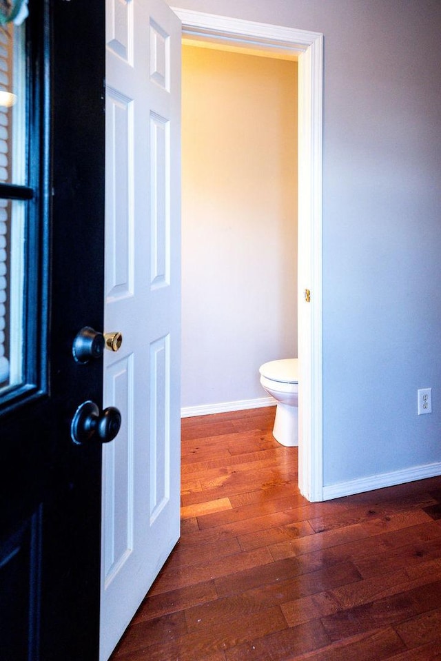 bathroom featuring hardwood / wood-style floors and toilet