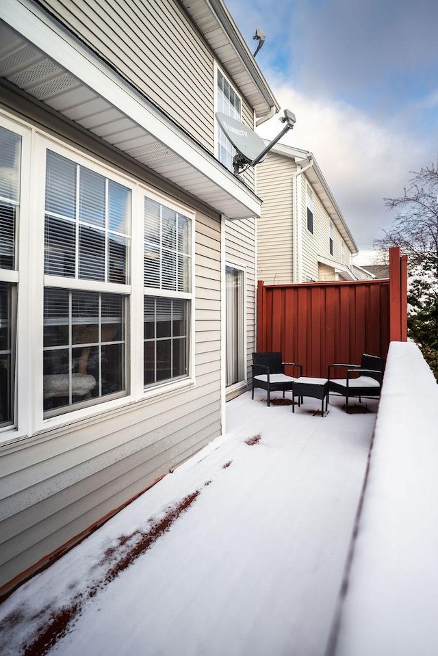 snow covered patio featuring an outdoor living space