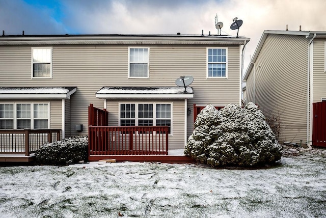 snow covered property with a deck