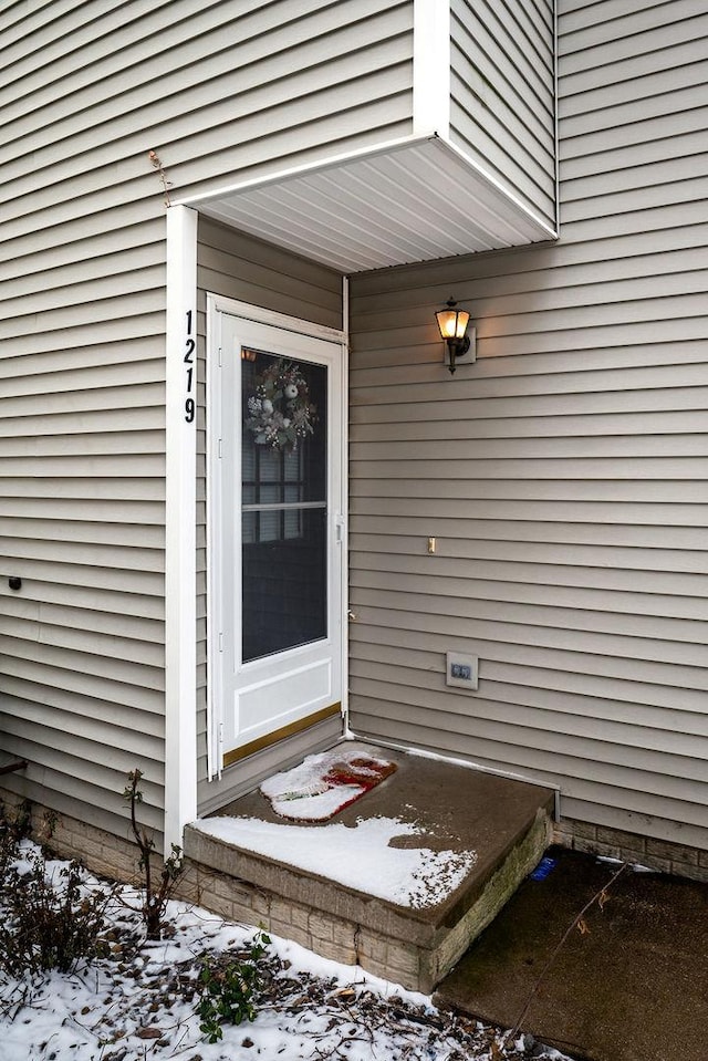 view of snow covered property entrance