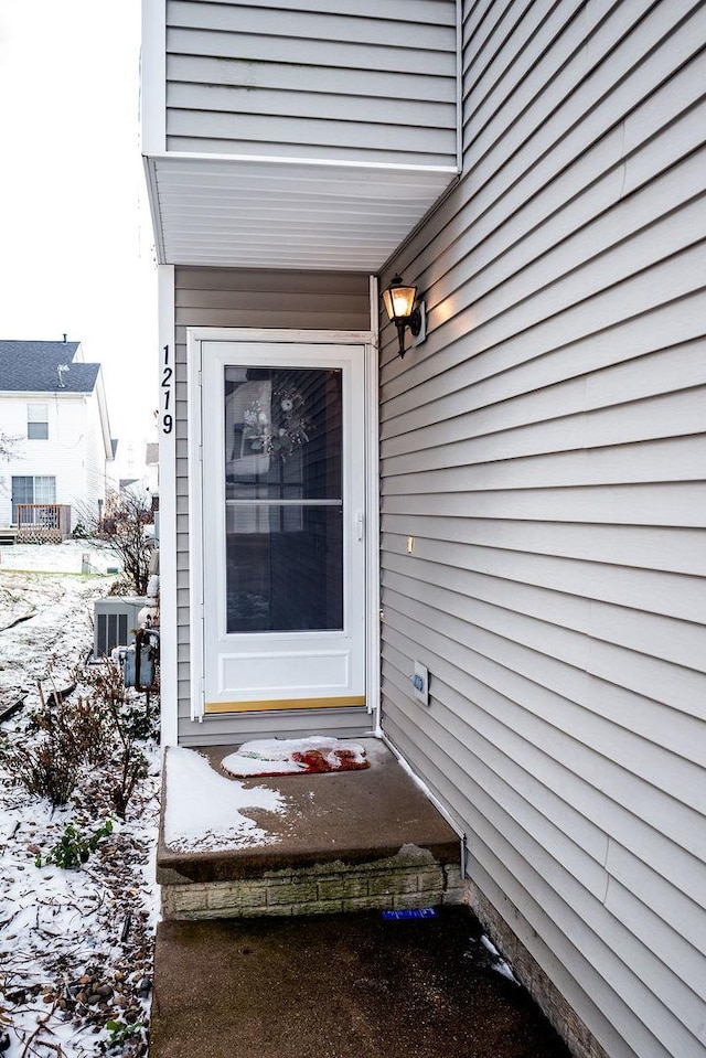 view of snow covered property entrance