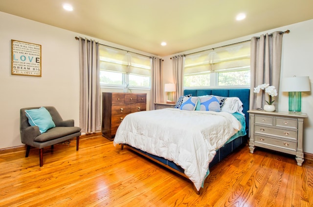 bedroom featuring hardwood / wood-style floors and multiple windows