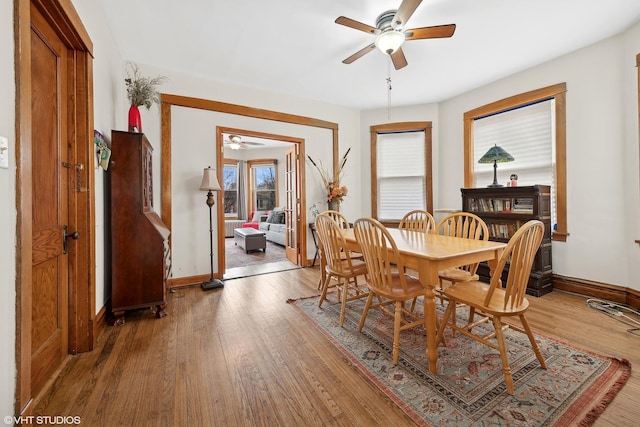 dining room with light hardwood / wood-style floors and ceiling fan